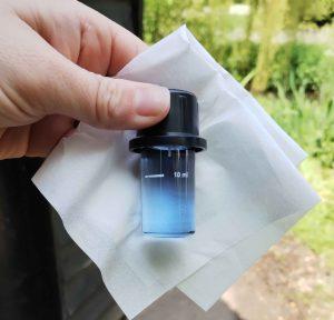 A glass cuvette with blue liquid in.